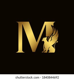 Griffin silhouette inside gold letter M. Heraldic symbol beast ancient mythology or fantasy. Creative design elements for logotype, emblem, monogram, icon or symbol for company, corporate, brand name.