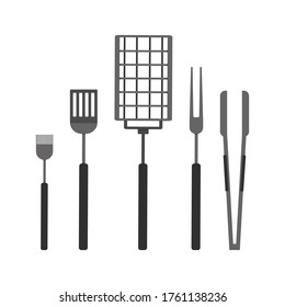 grilling set: a grill grate, fork, silicone basting brush, tongs and spatula; grill party on a backyard concept, roasting grill tools