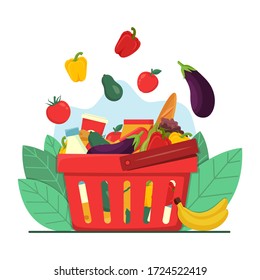 Grocery shopping concept. Red plastic shopping basket full of groceries products. Fruits and vegetables falling down into basket, concept for retail. Grocery store. Healthy organic fresh natural food.