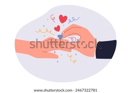 Groom puts wedding ring on bride hand during marriage ceremony in temple. Wedding ring made of pure gold with diamond for future wife from gallant gentleman who wants to start family