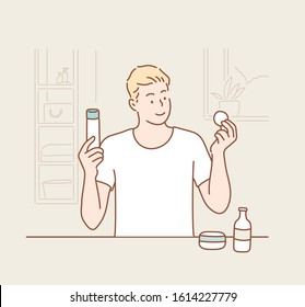 grooming, skin care and people concept - smiling young man cleaning his face with cotton pad. Hand drawn style vector design illustrations.