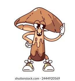 Groovy brown mushroom cartoon character holding cap. Funny retro boletus standing in sneakers with funky smile, forest mushroom mascot, cartoon fungus sticker of 70s 80s style vector illustration