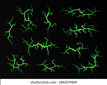 Ground cracks with magic green light isolated on a black background. Abstract volcanic fissures set, vector decorative elements. Magic spell concept.