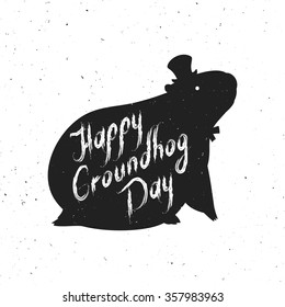 Groundhog Day greeting card. Hand-written lettering on vintage grunge background. Groundhog Day emblem with the silhouette of a marmot in a retro style.