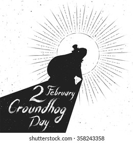 Groundhog Day greeting card. Hand-written lettering on vintage grunge background. Groundhog Day emblem with the silhouette of a marmot in a retro style.