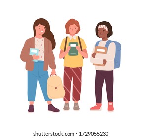 Group of adorable diverse classmates girls standing together vector flat illustration. Happy female pupils friends smiling holding books and backpacks isolated on white. Joyful kids mate