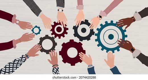 Group arms and hands of multicultural business people connecting and joining pieces of gears on a table. Concept of teamwork brainstorming or meeting between colleagues and co-worker