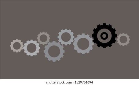 A group of black gears in various sizes isolated on grey background. Concept of industrial, engineering, factory, process, machine and etc. There’s a copy space for your text.