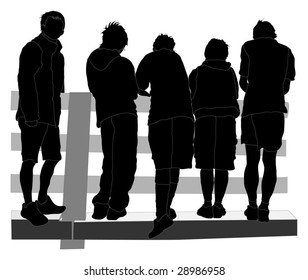 Group of boys standing on a platform watching an event