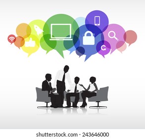 Group of business people discussing in a white background with colorful speech bubbles above containing social networking symbols.