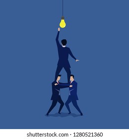 Group of businessman shouldered to reach the idea.Symbol of teamwork.