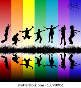 Group of children jumping over a rainbow striped background