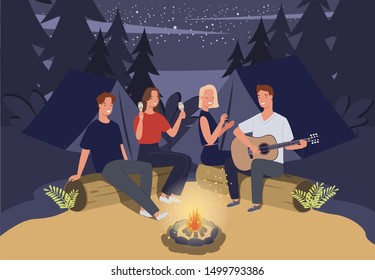 Group Of Friends Camping. They Are Sitting Around Camp Fire And Playing Guitar