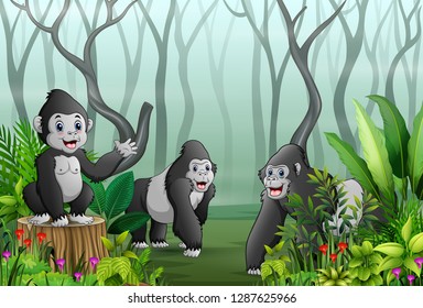 A Group Of Gorillas In A Forest With Dry Tree Branches Background