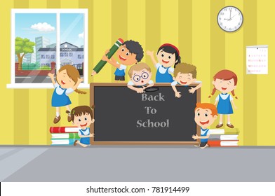 Group of happy school children with chalkboard in clasroom. back to school concept