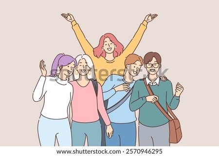 Group of happy students happily pose for group portrait after finishing lecture at university. Positive students smiling and waving enjoying carefree adolescence and free time for friends