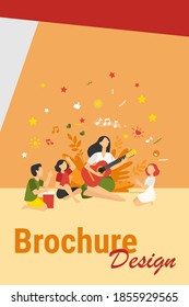 Group of kids clapping hands at their teacher playing guitar. Children enjoying music class outdoors. Can be used for daycare, education, musical school concepts