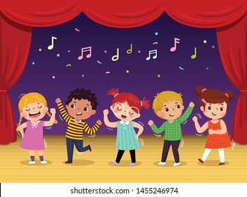 Group of kids dancing and singing a song on the stage. Children’s performance.