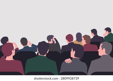 A group of people sitting in rows in a theater or conference hall, viewed from behind, watching a presentation on a large screen.