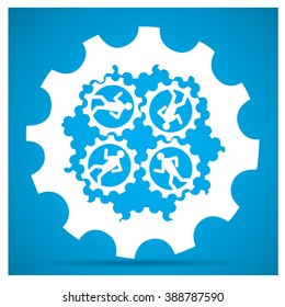 Group of people working together on pieces of gear on a blue background