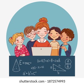 Group of school kids with teacher looking at laptop in the classroom