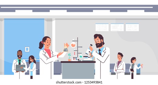 group scientists working with microscope in laboratory doing research man woman making scientific experiments mix race doctors in lab interior portrait workplace horizontal svg