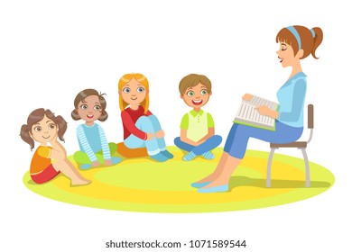 Group Of Small Kids Sitting Around The Teacher Reading A Story