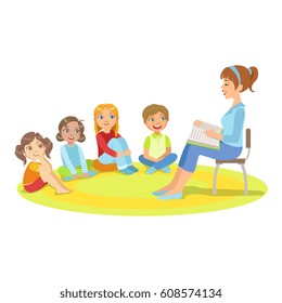 Group Of Small Kids Sitting Around The Teacher Reading A Story