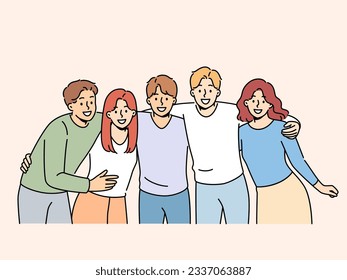 Group of teenagers high school students hug and laugh, enjoy being friends with peers and classmates. Team of happy teenagers looking at screen for advertising educational services