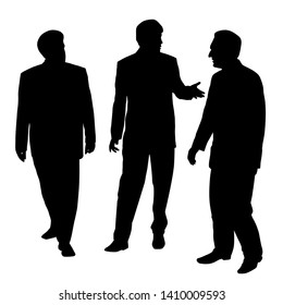 Group of three businessmen walking and talking