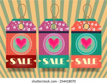 Group of three hanging tags with patterns on striped background