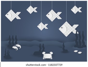 Group of white fish in paper cut style hanging with sea animal and seaweeds on navy blue background in vector design. 