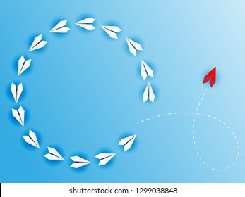 Group of white paper planes fly in a circle and one red paper plane pointing in different way on blue background. Business for new ideas creativity, innovative and solution concept.