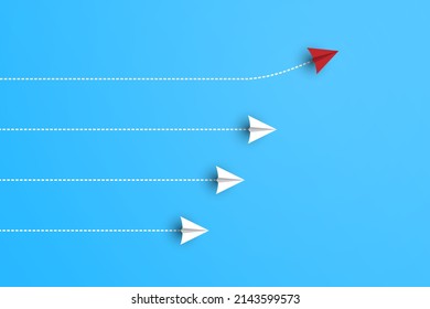 Group of white paper planes in one direction and one red paper plane pointing in different way on blue background. Business for new ideas creativity and innovative solution concepts.