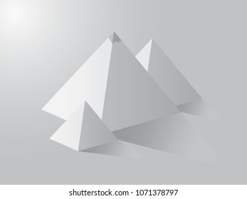 A group of white pyramids casting shadow on white background