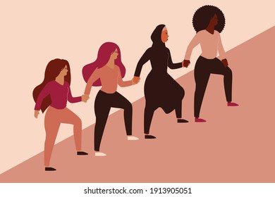 Group of women climbing highly and hold hands. Four different nationalities represent friendship and sisterhood symbol. Females support each others and hold hands. Women empowerment movement concept.