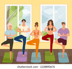 Group of young  people practicing yoga lesson standing in Vrksasana exercise, Tree pose with namaste gesture, working out, indoor, studio. Healthy lifestyle concept