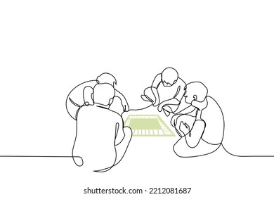 group of young people sit on the floor in front of a card and play a board game - one line drawing vector. leisure concept with friends playing board games