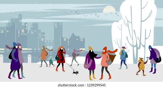 A groups of young urban girls and women in warm outer clothing  walk in the winter city quay
