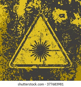 Grunge attention poster. Vector illustration of "Laser Hazard" sign on grungy dirty background in grey and yellow colors. It can be used as a poster, wallpaper, t-shirts design. Fully editable.