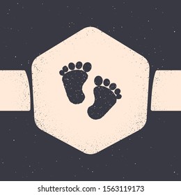 Grunge Baby footprints icon isolated on grey background. Baby feet sign. Monochrome vintage drawing. Vector Illustration