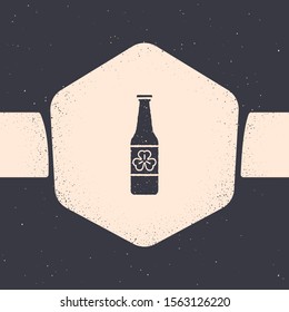 Grunge Beer bottle with four leaf clover icon isolated on grey background. Happy Saint Patricks day. Monochrome vintage drawing. Vector Illustration
