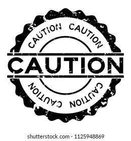 Grunge black caution word round rubber seal stamp on white background