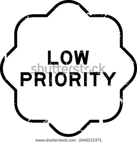 Grunge black low priority word rubber seal stamp on white background