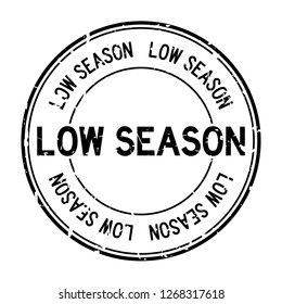 Grunge black low season word round rubber seal stamp on white background