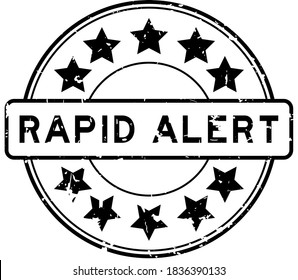 Grunge black rapid alert word with star icon round rubber seal stamp on white background