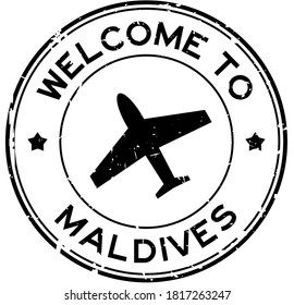 Grunge black welcome to Maldives word with airplane icon round rubber seal stamp on white background