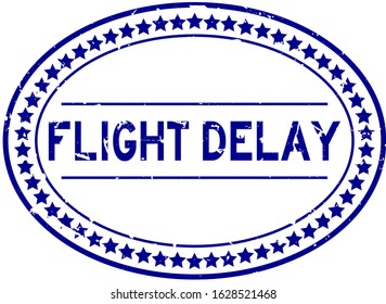 Grunge blue flight delay word oval rubber seal stamp on white background
