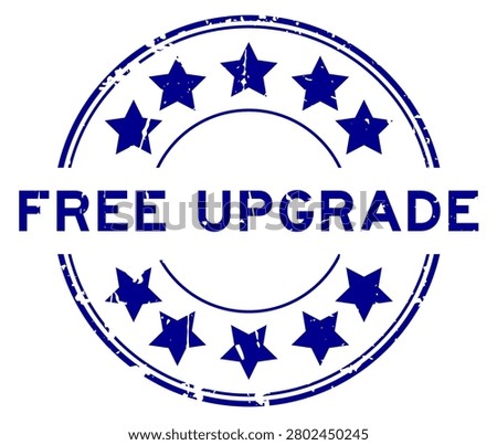Grunge blue free upgrade word round rubber seal stamp on white background
