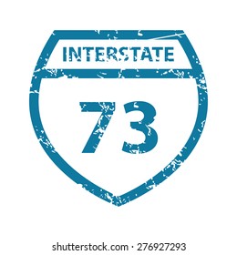 Grunge blue icon with image of shield and text Interstate 73, isolated on white